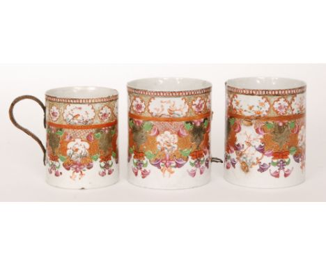 A Chinese Qing Dynasty Qianlong period 18th Century famille rose mug, hand painted with cartouche panels of exotic birds over