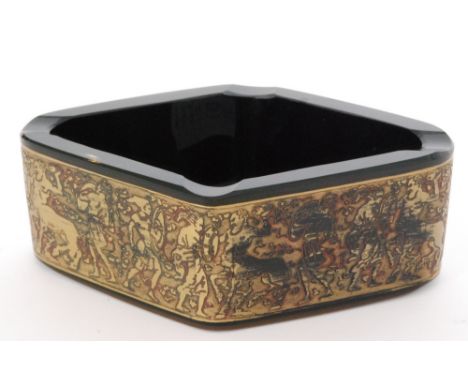 A 1920s Moser glass ashtray of diamond form decorated with a gilt Oroplastic band depicting centaurs in battle in relief over