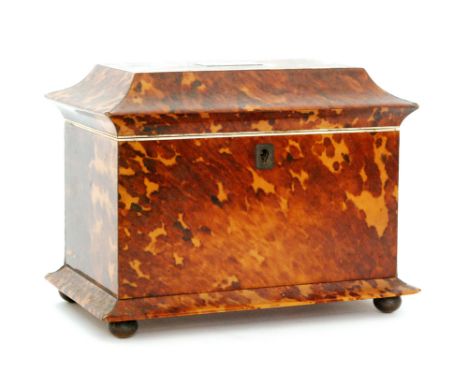 A 19th Century Regency tortoiseshell tea caddy of sargophagal form fitted with two divisions and covers, width 20cm