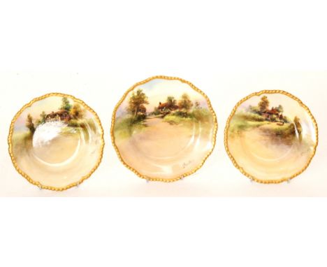 Three 1920s Royal Worcester hand painted side plates decorated by J. Hendry with a thatched country cottage, titled to the re