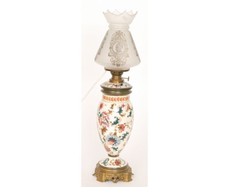 A Zolnay style overpainted cream patterned oil lamp in the traditional style with matching reservoir and etched shade, height