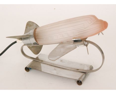 A later 20th Century chrome plated desk lamp in the Art Deco style modelled as an aeroplane with a moulded frosted glass shad