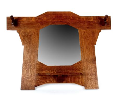 An early 20th Century Arts and Crafts Heals style oak wall mirror with two coat hooks and a small shelf beneath the mirror, 5