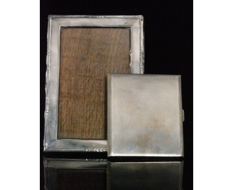 A hallmarked silver rectangular easel photograph frame with engine turned decoration and reeded borders, height 16cm, with a 