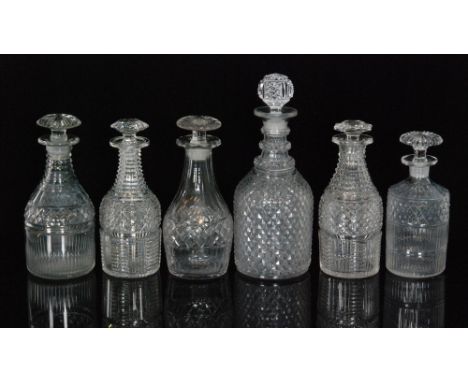 A group of six early 19th Century Regency clear crystal glass decanters comprising a diamond cut Prussian form decanter, two 