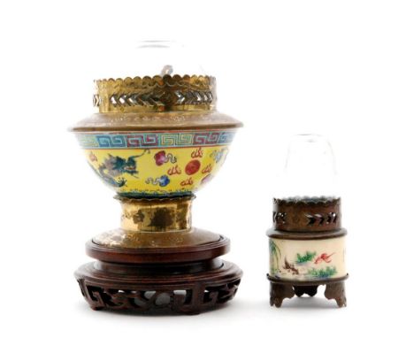 A Chinese opium lamp with glass shade and porcelain body depicting a dragon chasing a pearl on a yellow ground below a Greek 