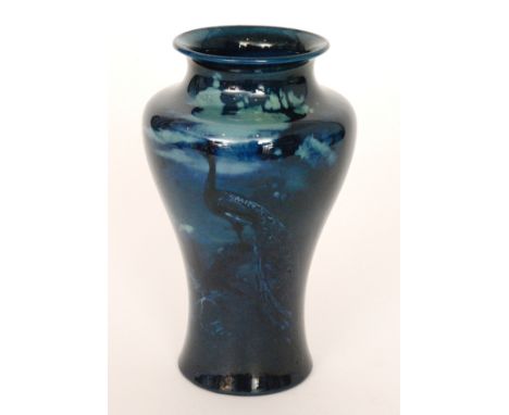 A Royal Worcester Sabrina Porcelain shape 2195 vase of high shouldered form decorated with a peacock perched on a rock beneat