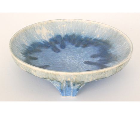 A Ruskin Pottery crystalline glaze shallow tri-footed bowl glazed in a tonal blue against a cream ground with light blue crys