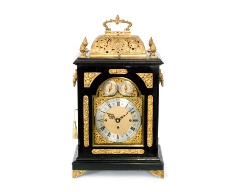 A late 19th Century ebonised and gilt metal mounted bracket clock, the pierced caddy top decorated with angelic figures centr