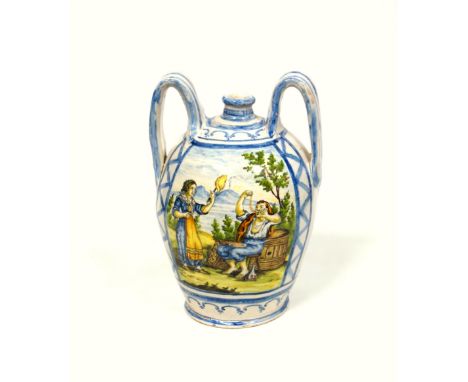 Italian Majolica ovoid wet drug jar with two wide strap handles, painted with a reserve of a figure sitting on a stool in fro