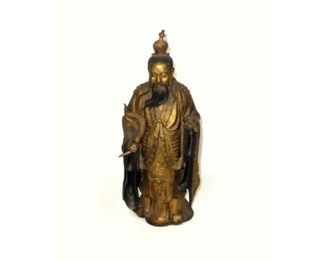 Chinese gilt bronze figure of a deity, standing and holding a gourd in his right hand and a scroll in his left, H.39cm
