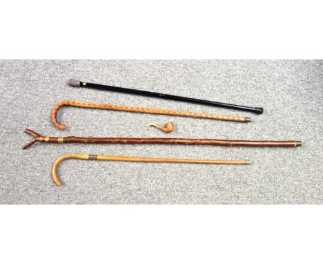 Ebonised walking cane with an Eastern white metal top, L.91.5cm; Cane with a silver collar inscribed " ES 1st Oct 1919"; 2 ot