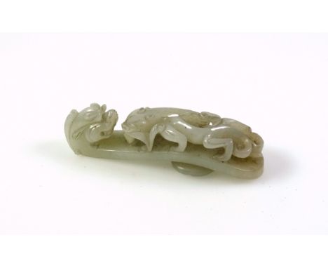 Chinese pale celadon jade belt hook, carved and pierced with a chilong confronting the dragon head terminal, 10cm.Condition:G