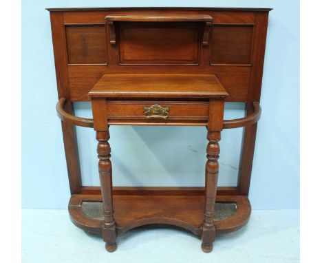 An Edwardian walnut hall-stand, with small shelf and panelled back, above a single drawer flanked by umbrella stands and rais