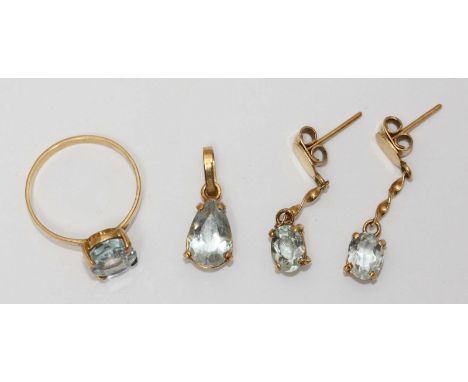 A four-piece 18ct gold jewellery set comprising a ring, a pendant and a pair of drop earrings, all set with aquamarines. Gros