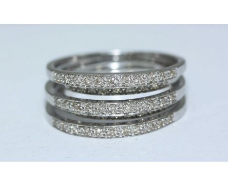 A 9ct white gold diamond ring, designed as five joined bands of alternating height, each channel set with diamonds, 51 diamon