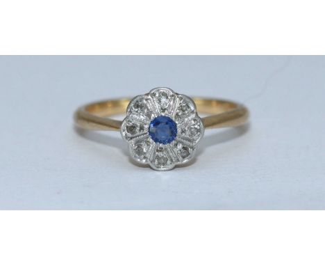 An 18ct gold, sapphire and diamond daisy cluster ring, rub-over setting, central sapphire surround by 8x eight-cut diamonds, 