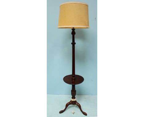 An early 20th century mahogany standard lamp waiter, with carved and turned support and raised on splayed, tripod base. 190cm
