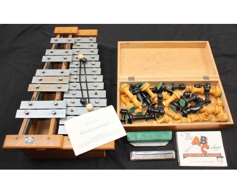 A wooden Hohner glockenspiel and a Hohner harmonica together with a wooden chess set with large playing pieces.