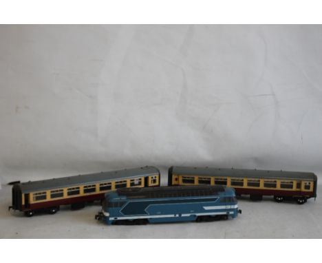 AN UNBOXED O GAUGE LIMA DIESEL LOCOMOTIVE and two unboxed LMS carriages.
