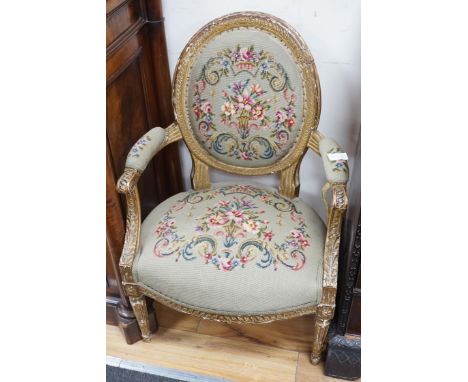 A 19th century French giltwood and composition fauteuil with tapestry upholstery, width 59cm, depth 46cm, height 90cm