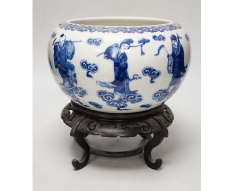 A 19th century Chinese blue and white ‘eight immortals’ alms bowl, apocryphal Qianlong seal mark, 25cm diameter (a.f.), wood 