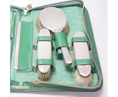 A cased George V five piece silver mounted mirror, brush and comb set, William Comyns &amp; Sons Ltd, London, 1935.