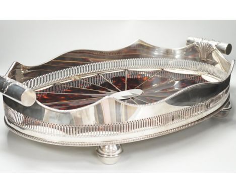An unusual Adam style tortoiseshell and mother-of-pearl inlaid plated oval with ‘paterae’ decoration, 65cm wide
