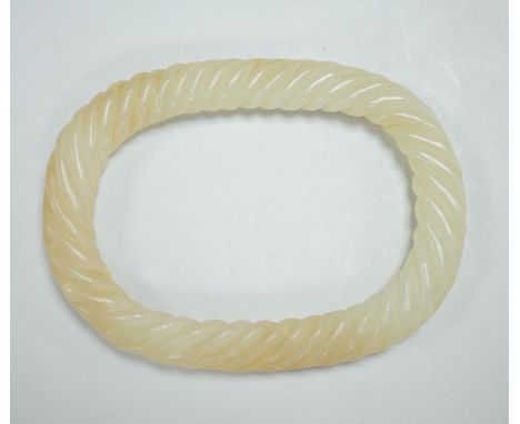A Chinese pale celadon jade rope twist bangle, 8.3cm wide