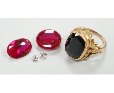 A 14k yellow metal and hematite? set signet ring, size K, gross weight 7.9 grams, together with four unmounted cut stones inc