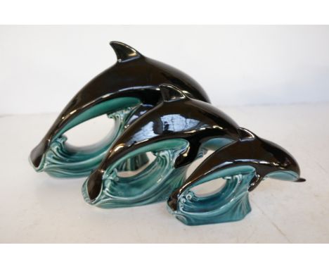 3 Graduating Poole pottery dolphins 