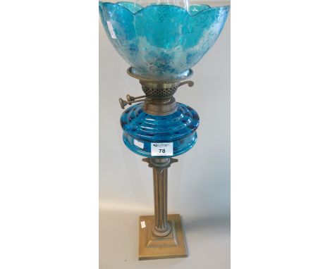 Brass double burner oil lamp with coloured glass reservoir on brass fluted column with square stepped base, petal shaped colo