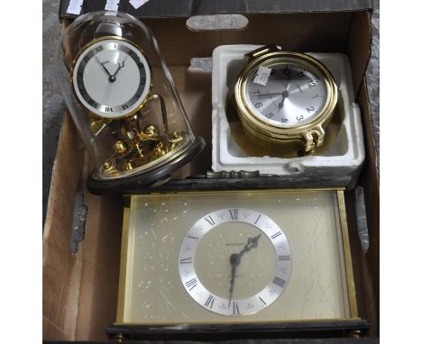 Small box containing small glass domed mantle clock with Roman numerals, a brass and plastic rectangular mantle clock with Ro