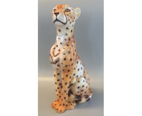 Modern ceramic study of a seated cheetah. 49cm high approx. (B.P. 21% + VAT) No obvious damage noted.
