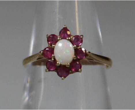 9ct gold opal and red stone dress ring, probably garnet. 1.4g approx.(B.P. 21% + VAT) 