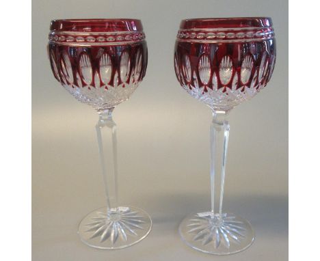A pair of Waterford ruby flash cut hock glasses. (2) (B.P. 21% + VAT)Marked Waterford to the foot of each glass. Sticker/glue