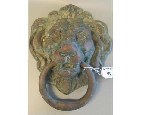 Heavy cast metal door knocker in the form of a lion mask with ring. 23 x 20cm approx. (B.P. 21% + VAT) Very dirty.