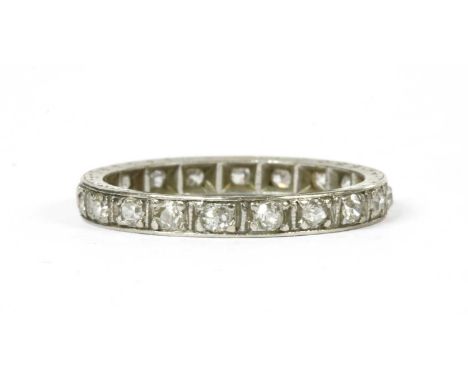 A diamond full eternity ring, a row of old eight cut diamonds, with one old brilliant cut replacement, grain set to engraved 