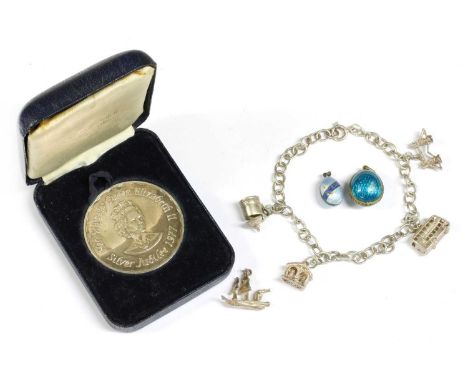 A silver guilloché enamel egg pendant, together with a silver gilt example, a silver charm bracelet, one loose silver charm, 