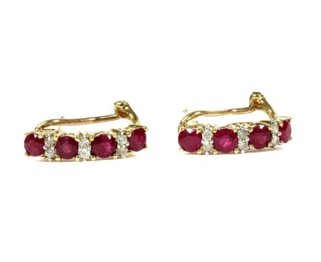 A pair of 9ct gold ruby and diamond half hoop earrings, a row of alternating circular mixed cut rubies and pairs of brilliant