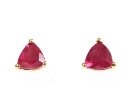 A pair of gold single stone ruby stud earrings, a triangular mixed cut ruby, possibly fracture filled, claw set, to post and 