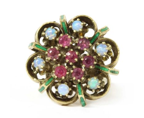 A gold opal, ruby and enamel cluster ring, a cluster of circular mixed cut rubies claw set to the centre, to surround of cabo