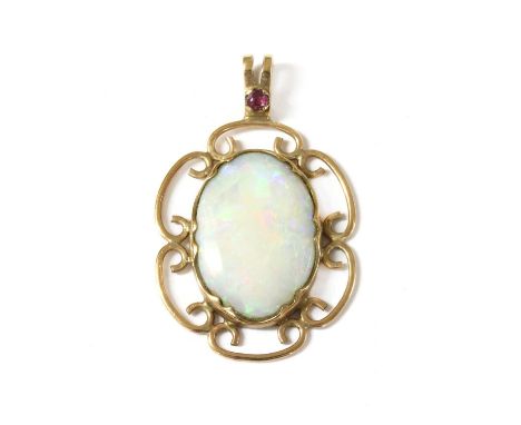 A 9ct gold opal and ruby pendant, an oval cabochon opal, rub set to scrolling frame, with split bale set with a circular mixe