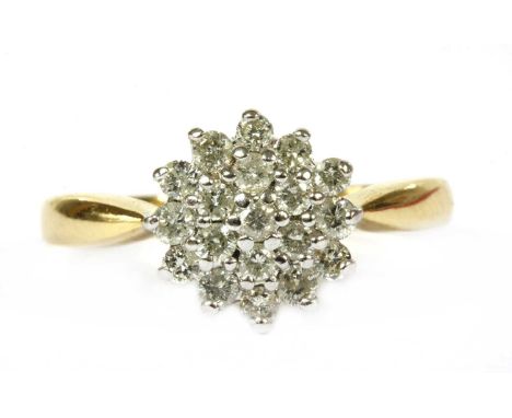 An 18ct gold diamond cluster ring, eight cut diamonds, claw set to the white gold circular head, to yellow gold solid shoulde