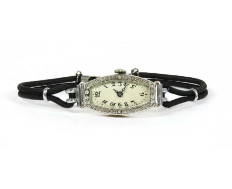 A ladies' Art Deco diamond set cocktail watch, a tonneau-shaped case 26 x 15mm, with silvered dial black Arabic numerals and 