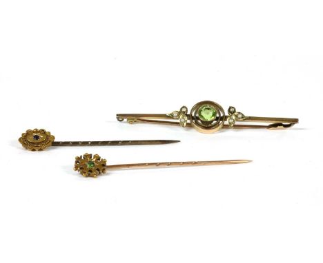 An Edwardian gold peridot and split pearl bar brooch, with pin and safety catch, marked 9ct, 58mm long, 3.22g, with a case by