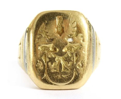 A gold signet ring, the rectangular head with engraving, worn, to tapered shoulders and a plain shank, tested as approximatel