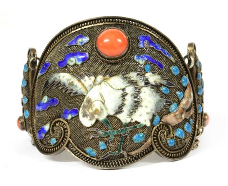 A Chinese silver gilt coral and enamel hinged bangle, c.1930, the mesh ground decorated with herons and clouds in polychrome 