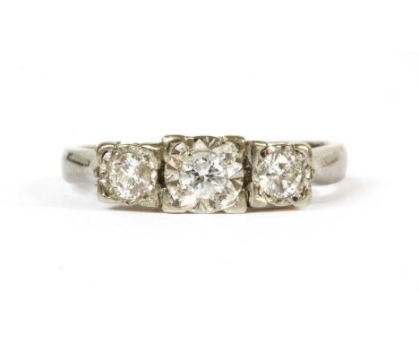 A 9ct white gold three stone diamond ring, a row of graduated brilliant cut diamonds, grain set to illusion collets, to open 