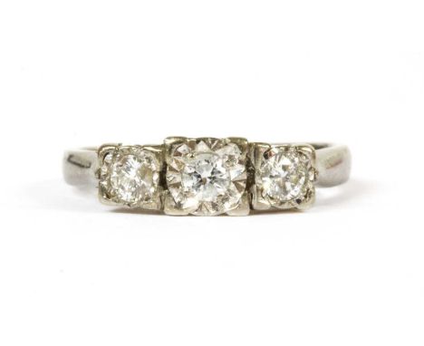 A 9ct white gold three stone diamond ring, a row of graduated brilliant cut diamonds, grain set to illusion collets, to open 